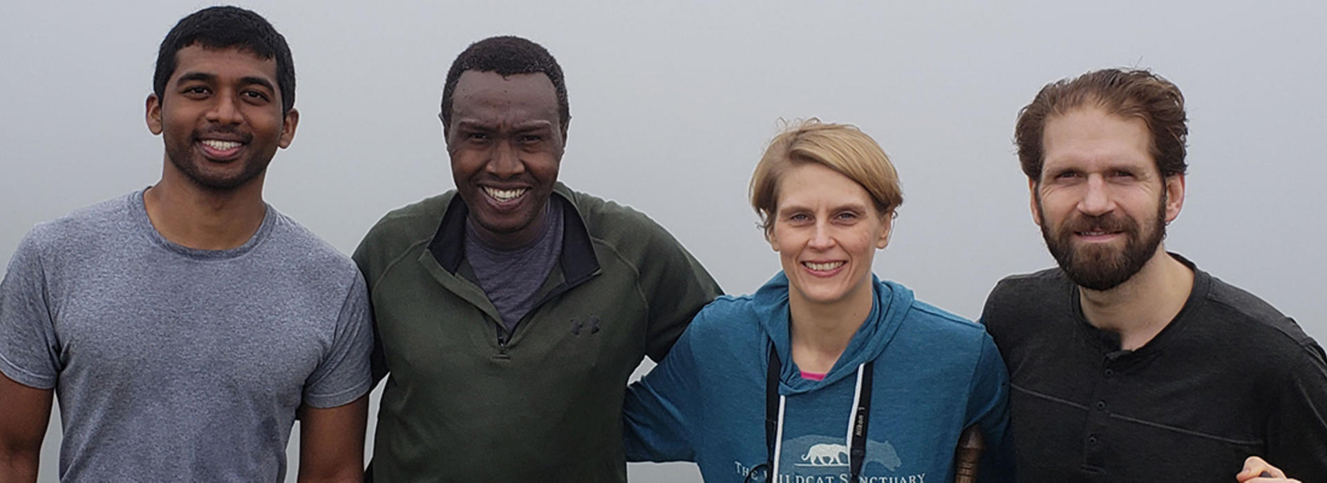 four anesthesiologists hiking in Uganda
