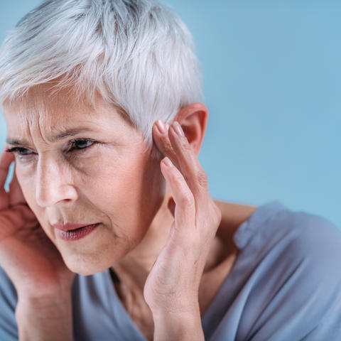 Woman suffering from tinnitus